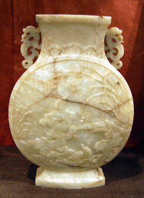 The carved ivory and brown mottled jade jar sold for $20,700.