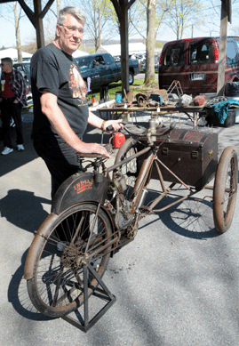 Dick Ollhoff with a 1906 Indian "camelback†tricar, of which there are a "half-dozen known surviving examples.†The Tomahawk, Wis., dealer had been riding the bike around the market earlier that morning.