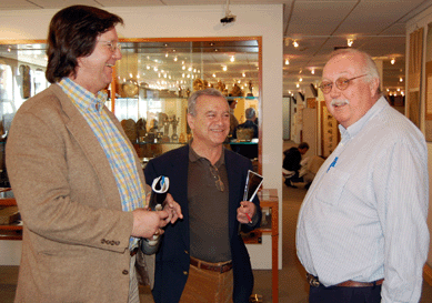 Area dealers Peter Combs and Emmanuel Tiliakos jest with James F. Callahan, head of Skinner's Asian arts department, during the sale preview. 