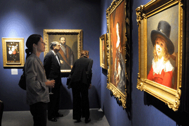 Shoppers admire a variety of paintings in the booth of Adam Williams Fine Arts, New York City, including "Portrait of Lady Mary Fane†by Sir Peter Lely.