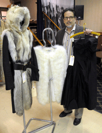 Auctioneer Charles Whitaker with a few of the Doris Duke couture lots. The Yves Saint Laurent leather and fox coat, left, sold at $1,035, the marabou feather coat, center, $517 and the Madame Gres strapless black silk cocktail dress realized $5,750.