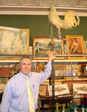 Auctioneer John McInnis is pictured below the copper Hamburg rooster weathervane attributed to L.W. Cushing and Sons that sold for $18,400.