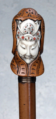 An elephant ivory cane carved with the head of a shogun within a hood of carved boxwood sold for $6,900.