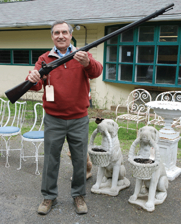 Dom Navarra, owner and auctioneer at Hyde Park Auctions, shows off the Revolutionary War flintlock that attracted more than eight absentee bids, many phone and floor bids, before selling to a Virginia collector at $14,375.