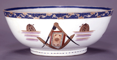 The Chinese Export porcelain punch bowl is decorated with Masonic symbols of columns, a square and compass and beehives. 