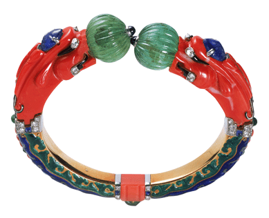 The Chimera bangle, a carved coral, emerald, sapphire and diamond bracelet highlighted by green, blue and black enamel decoration. Cartier Paris, 1928. Nick Welsh ©Cartier.