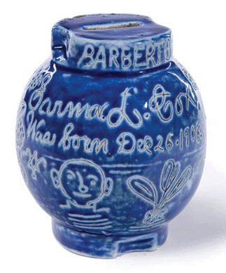 This whimsical stoneware bank with a bright cobalt glaze and incised decoration of a child, flowers, a bird and the inscription "Barberton Ohio Earma L. Cox Was born Dec 25 1908,†sold for $5,875.