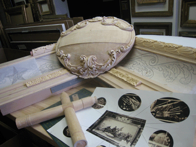 A carved shield is one of four at each corner of the frame. Note the period photographs of the painting's frame being used for reference.