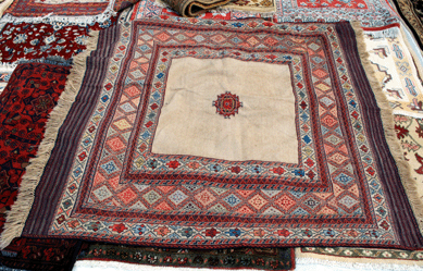 Amin Noori, New Milford, Conn., spread a needle-made Suzani antique embroidered and decorative tribal textile on a sea of Oriental rugs.