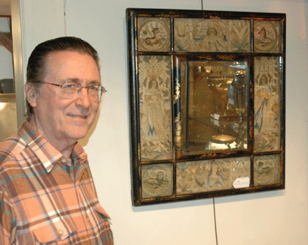 Tom Schwenke with the top lot of the sale, a rare Charles II japanned and chinoiserie decorated needlework mirror that sold for $23,400. ⁁ntiques and The Arts Weekly photo, R. Scudder Smith.