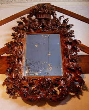 Italian carved oak mirror in the manner of Andrea Brustolon, late Seventeenth or early Eighteenth Century.