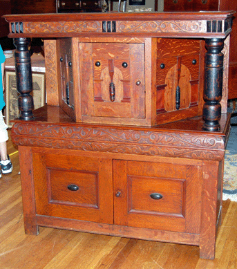 The carved oak and pine court cupboard brought $8,120 from a dealer in the gallery. 