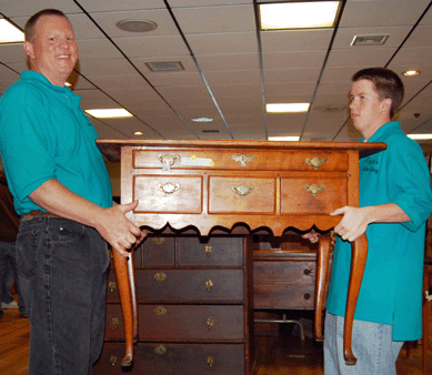 Bob Wyman and his son Kevin run a Connecticut Queen Anne cherry dressing table that a dealer won for $4,032.