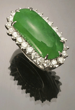 This 18K white gold, green jadeite jade and diamond dinner ring was reported stolen.