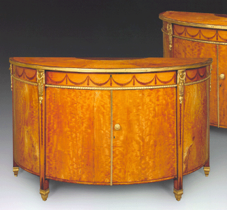 The commodes are constructed of deal, mahogany and oak, veneered with figured West Indian satinwood and holly with rosewood bandings, hare-wood and burr-yew marquetry and ormolu mounts.  