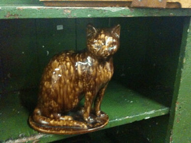 The ceramic cat was found sitting around.