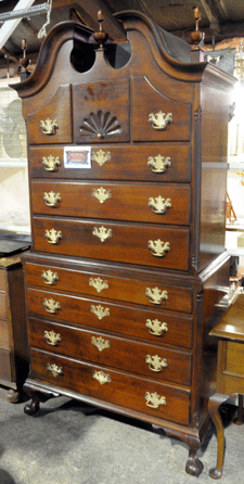 The top lot of the auction came as a cherry Chippendale chest-on-chest attributed to Hartford cabinetmaker George Belden sold at $11,500.