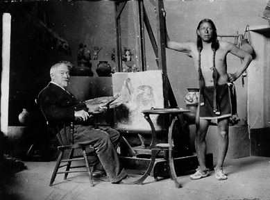 Couse seated in his studio with Ben Luhan, a Taos Pueblo Indian, who became a favorite model and longtime family friend. Couse family archives.