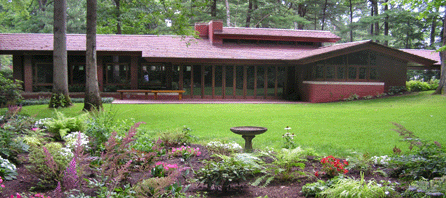 The manicured and private backyard of the Frank Lloyd Wright-designed home built for Lucille and Isadore J. Zimmerman is inviting, almost becoming a part of the living space as viewed through the expansive glass walls that the architect placed with a passive Southern exposure.