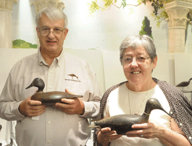 Ted and Judy Harmon with the Stevens blue wing teal that sold for $37,950 and the Wilson willet that realized $80,500.