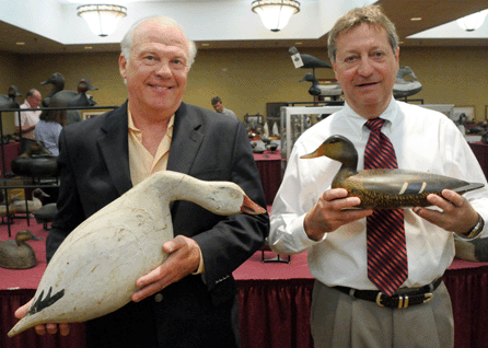 Gary Guyette, left, and Frank Schmidt with two of the auction's better decoys, the John Tax snow goose that sold for $55,200 and the Charles Perdew mallard for $23,000, respectively.