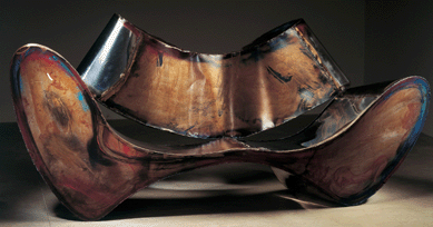 One of Arad's most impressive creations of the 1990s was "D-Sofa,†1994, shown here as a prototype, a luxuriously designed resting place made of patinated, painted, oxidized stainless steel and mild steel. It measures a capacious 38 3/16  inches by 7 feet 1-inch by 35 7/16 inches. Prototype by One Off, London. Courtesy of private collection, United States. ⁅rik and Petra Hesmerg photo