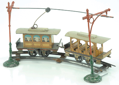 Pair of finely lithographed Issmayer clockwork tin trolleys, made in Germany for US market, drew $9,200. 