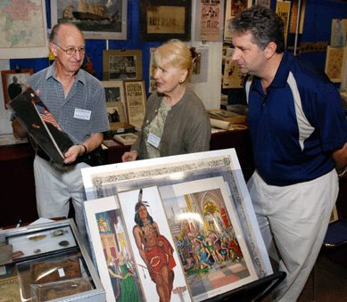 Leon Jackson, Gloucester, Mass., left, shows promoters Arlene Shea and Gary Gipstein an American flag used as a dinner gift in 1929.