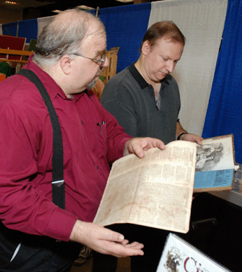 Eric Caren, right, shows Vincent Golden, curator of newspapers and periodicals of the American Antiquarian Society in Worchester, Mass., an antislavery newspaper, Ultimatum, printed in New London, Conn., in 1838.