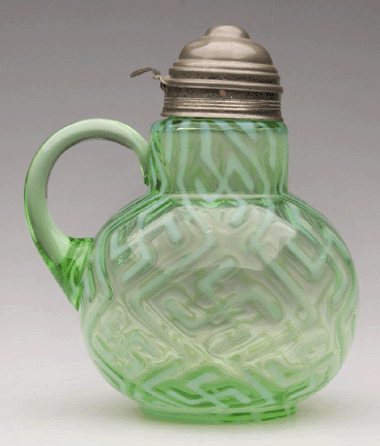 Top lot in the June 27 auction of Nineteenth and Twentieth Century glass was this swastika syrup pitcher, which sold for $4,888.