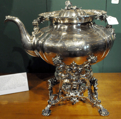 The monumental Russian silver tea server on stand with baroque decoration and a swing handle with an ivory insert realized $12,650.