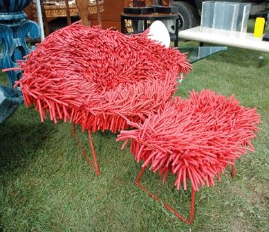 Hairy Bertoia †comprising more than 2,500 strands of pulsing red rubber was this spiny-looking but plush chair and ottoman by Douglas Homer at Blue Goose, New York City ⁄ealer's Choice