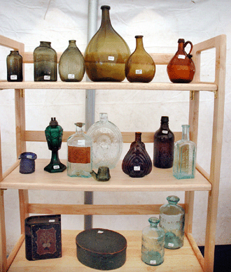 The dealers in the so-called "Vermont Tent†at Green Acres are up early on Tuesday to make sales in this popular destination. Jeff Noordsy, Cornwall, Vt., brought a collection of early glass bottles, mostly Connecticut-made, circa 1790s‱820s.