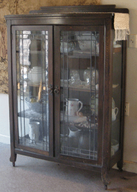 This leaded glass front antique cabinet, from early 1900s, is reported missing.