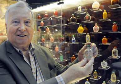 Dealer Francois Lorin with a snuff bottle from a collection that ranged in price from $1,000 to $40,000. Asiantiques, Winter Park, Fla.