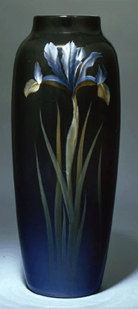 Carl Schmidt produced the 13¾-inch vase decorated with irises and having the highly desirable Black Iris glaze for the Rookwood Pottery in 1909. John Cotton Dana purchased a number of pieces for the Newark Museum in 1914.