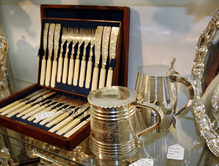 The Silver Vault, Woodstock, Ill., displayed 1868 flatware with ivory handles and sterling blades and tines, an 1883 Russian tankard by Agazfonov and a London barrel-shaped tankard by Chawner dated 1787.