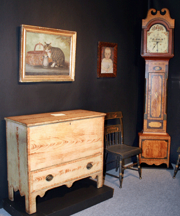 "This blanket chest is my favorite of all we have ever owned,†Tom Jewett of Jewett & Berdan, Newcastle, Maine, said of this Eastham or Duxbury, Mass., example with original strap hinges and bold tombstone cutouts. Right is a Shaftsbury, Vt., painted tall case clock.