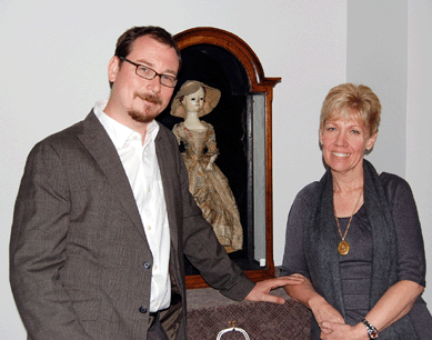 Andy and Becky Ourant, Adamstown, Penn., dealers and longtime friends of Richard Wright, pause for a picture with the English Queen Anne doll during the exceptionally busy sale preview.