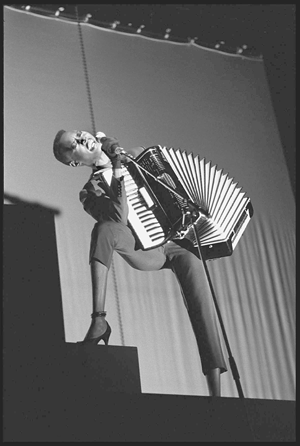 Grace Jones performing at Drury Lane Theater, London, 1981, by David Corio. A live-performance shot that is a tour de force of line. Gelatin silver print. ©David Corio