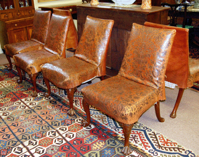 The imposing set of six George II mahogany stool-back chairs with embossed Fortuny leather seat covers brought $35,650 from a Chicago area dealer who beat out international competition.