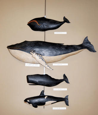 A single telephone bidder paid a total of $16,545 for the group of four carved whales by Clark Voorhees.