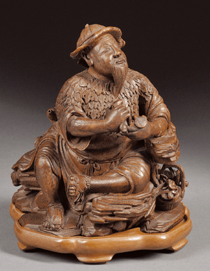 The Ch'ien Lung bamboo root carving in the form of an Immortal wearing a mugwort cape and seated on a rocky outcrop sold for $154,050.