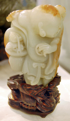 A Ch'ien Lung celadon green jade carving of an Immortal sold on the phone for $90,060.