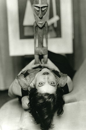 Around 1927, Man Ray staged this appropriately Surrealistic scene by posing "Simone Kahn,†wife of Surrealist leader Andre Breton, lying on her back and gazing at the viewer, while holding on her stomach a sculpted Vanuatu male figure from eastern Malekula. Photography, Surrealism and African art were a popular combination for a time. Collection of Edmunde Treillard ©Man Ray Trust/Artist Rights Society (ARS), NY/ADAGP, Paris.