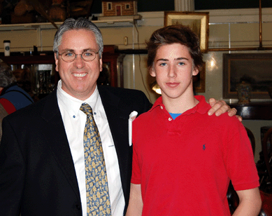 John McInnis Auctioneers is a family enterprise. Pictured with his father is Joseph McInnis, who handles Internet bidding and some phones.