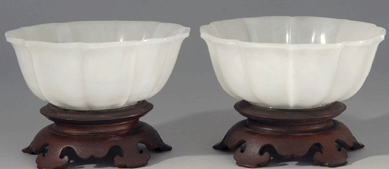 A Nineteenth Century pair of white jade bowls in lotus form realized $19,550.