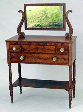 Well-crafted early Nineteenth Century American mahogany dresser with lyre carved supported mirror brought $1,840.