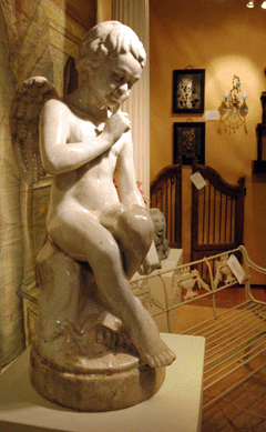 "Menacing Cupid,†a glazed terracotta statue of Cupid after Etienne-Maurice Falconet's (1716‱791) original marble sculpture, circa 1750, urges viewer discretion in the booth of Aileen Minor Antiques, Centreville, Md.