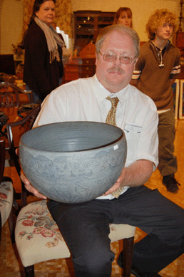 Channing Howard hoists a large bowl by New Hampshire potters Mary and Edwin Scheier that sold for $5,520.